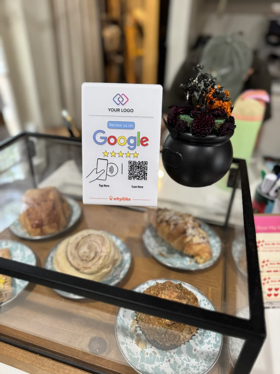 White custom-logo Google Review Stand beside a bakery display case